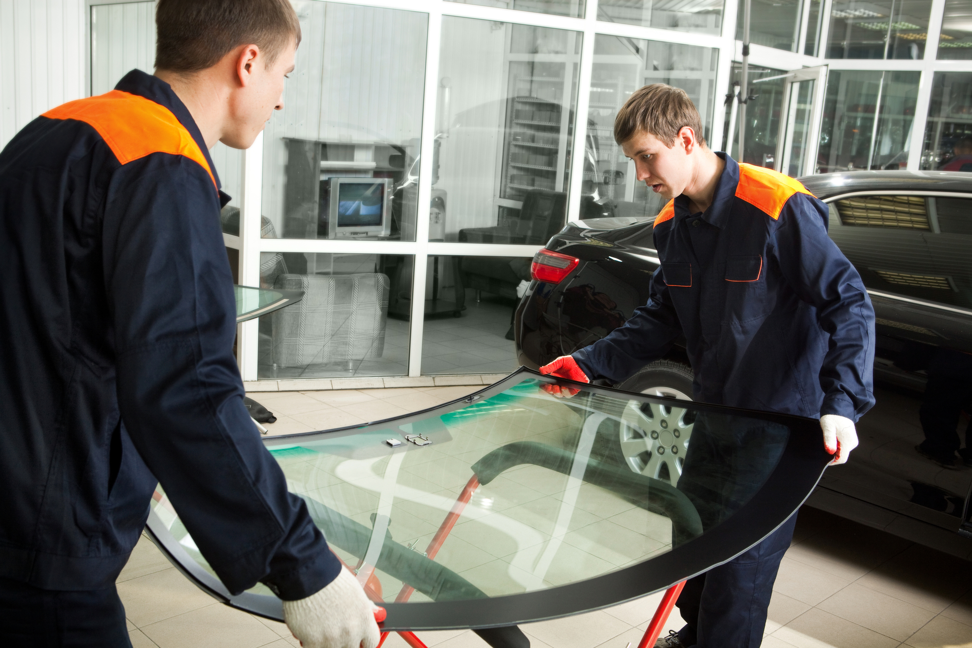 Two Mechanics Working In Auto Repair Shop