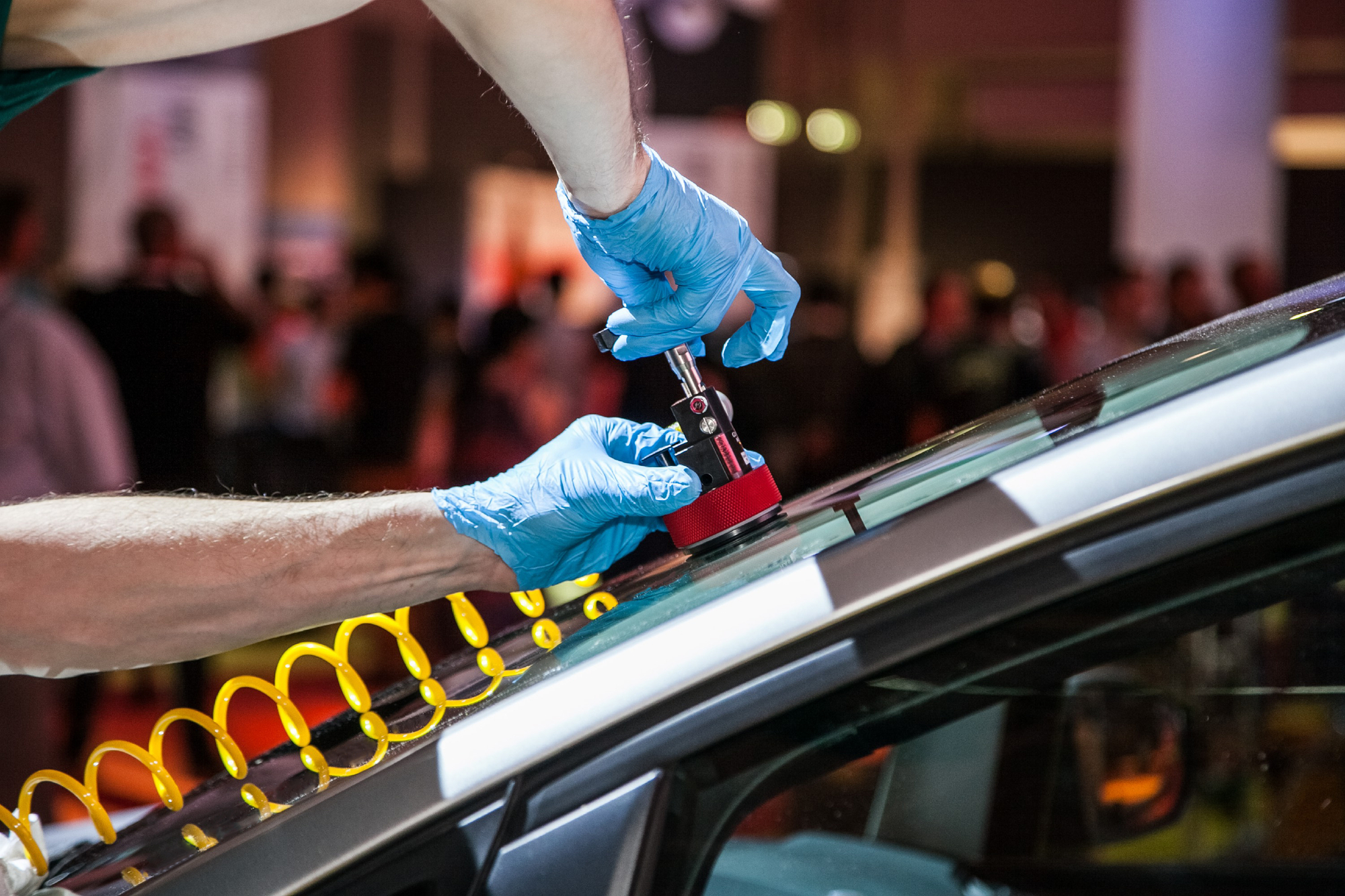 Workers Repairing Windshield On A Car